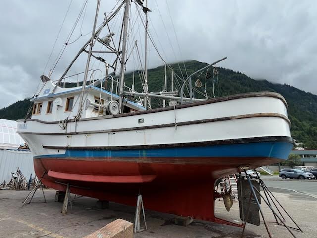 Fishing vessel on stands for damage assessment