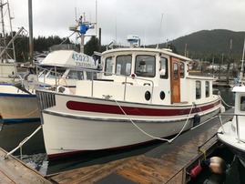 Pocket trawler docked in Alaska marina during vessel inspection.
