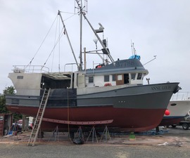 Commercial fishing trawler on stands for hull assessment