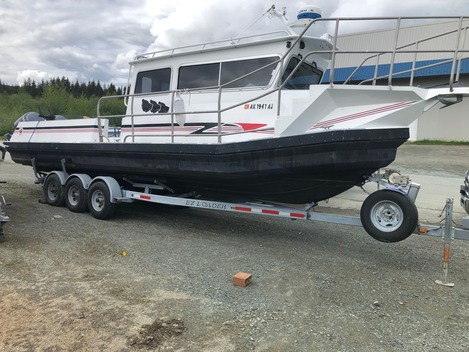 Landing craft on trailer with red stripe hull, Juneau AK